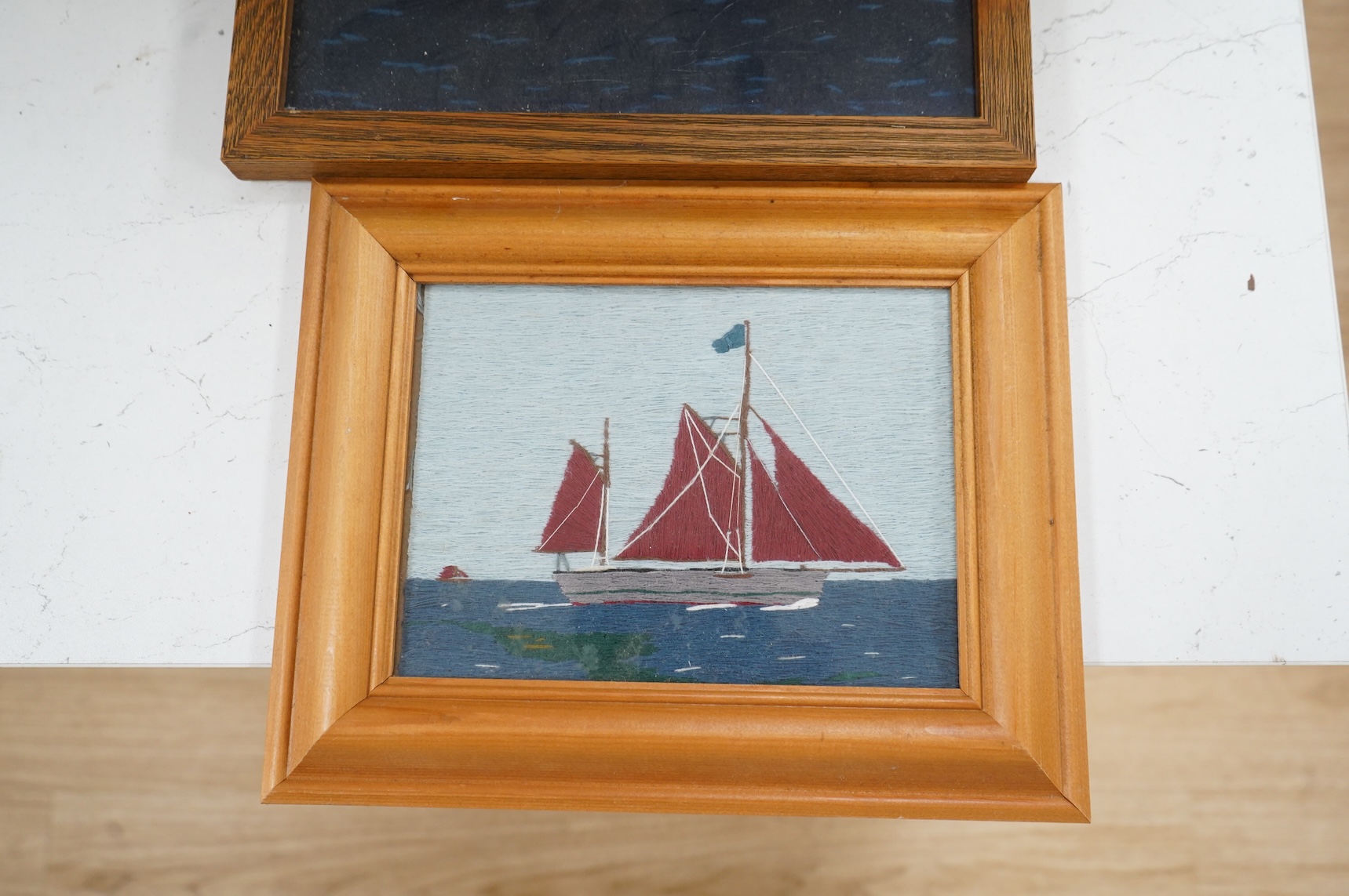 Two 20th century wool worked galleon embroideries and two similar yachting wool works, largest in decorative frame 36cm x 29cm